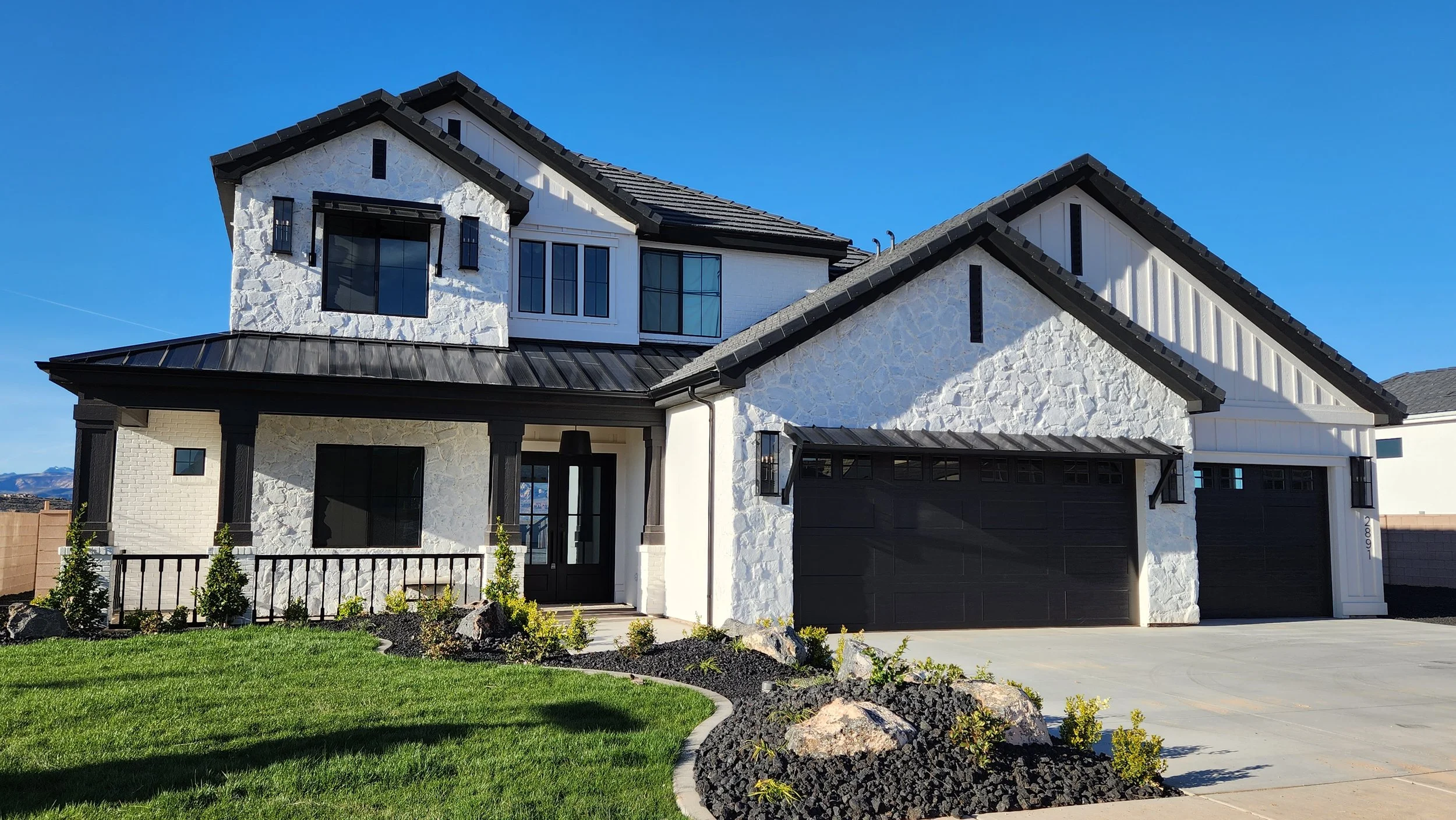 A handsome stone-and-board farmhouse with a sun-lit porch — the kind of home Krest helps clients into.