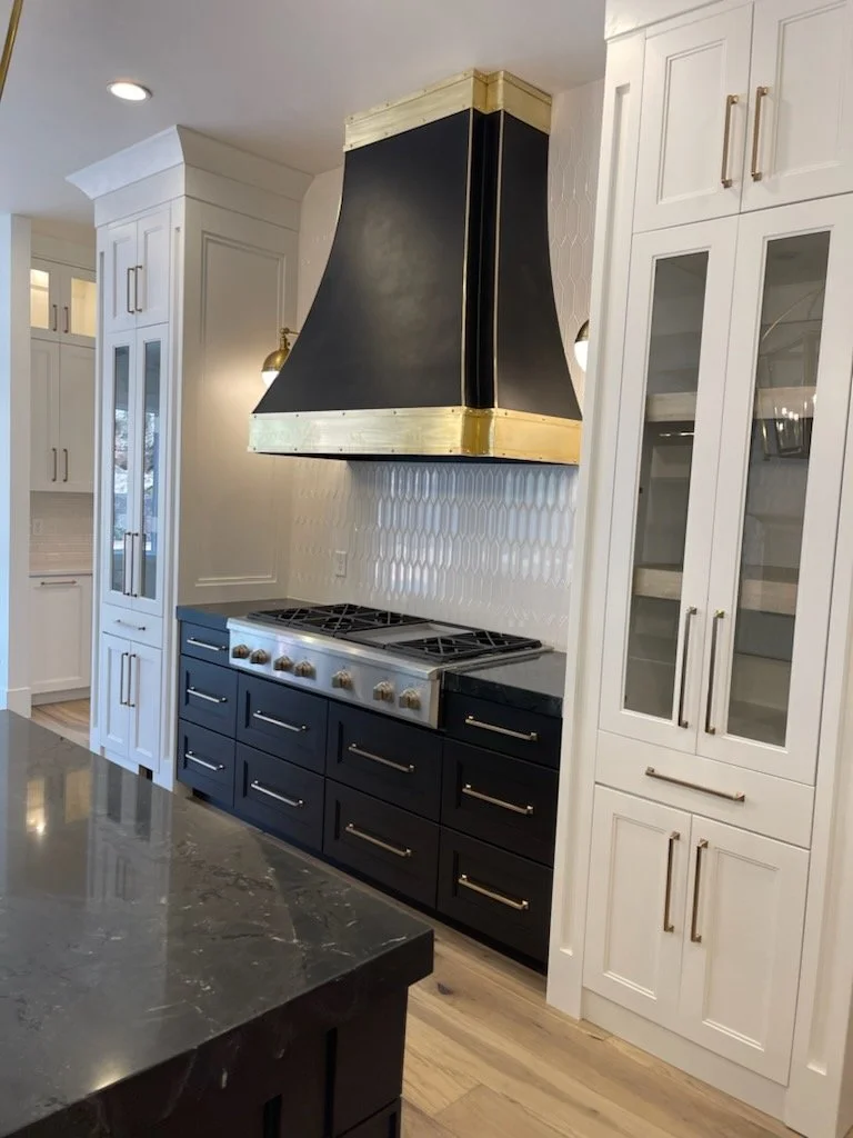 A handsome kitchen with a marble island and brass pendants — a conventional-loan home.